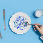 White plate with blue plastics on it