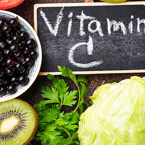 Image of fruits and a chalkboard with Vitamin C written on it