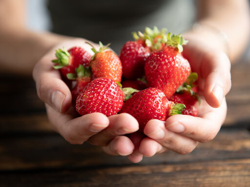 Closeup of hands holding strawberries