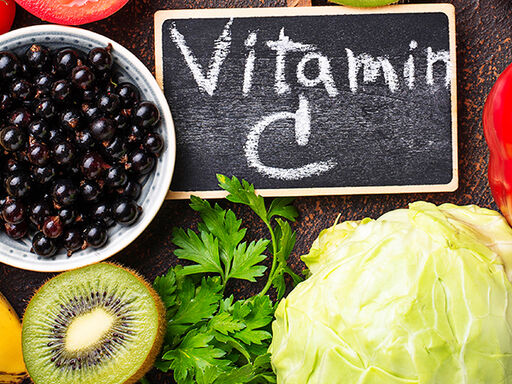 Image of fruits and a chalkboard with Vitamin C written on it